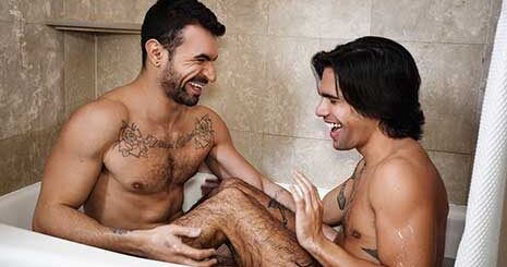 Ian Greene and Ty Mitchell playfully splash each other as they take a bath together. The pair dry off, and Ian pulls off Ty's towel and swats at his ass with it, then gets to his knees and rims his juicy peach.